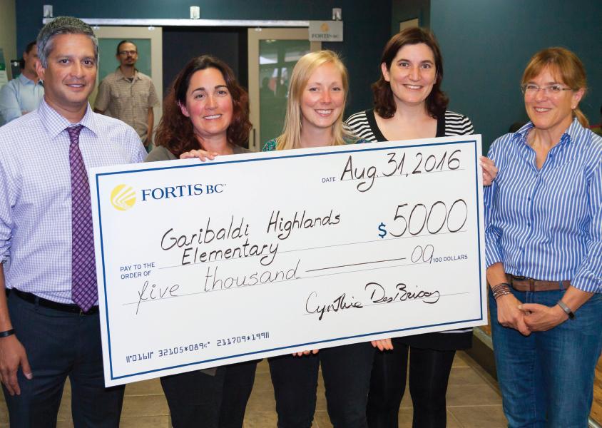 People stand behind a large cheque from FortisBC for $5000 to Garibaldi Highlands Elementary