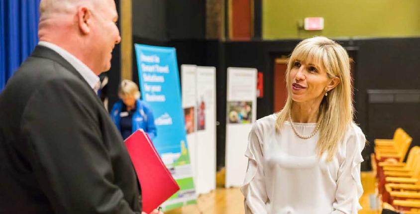 Woman talks to a man during an information session