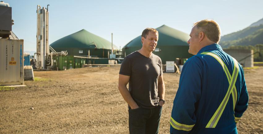 Two men talking outside a FortisBC RNG facility