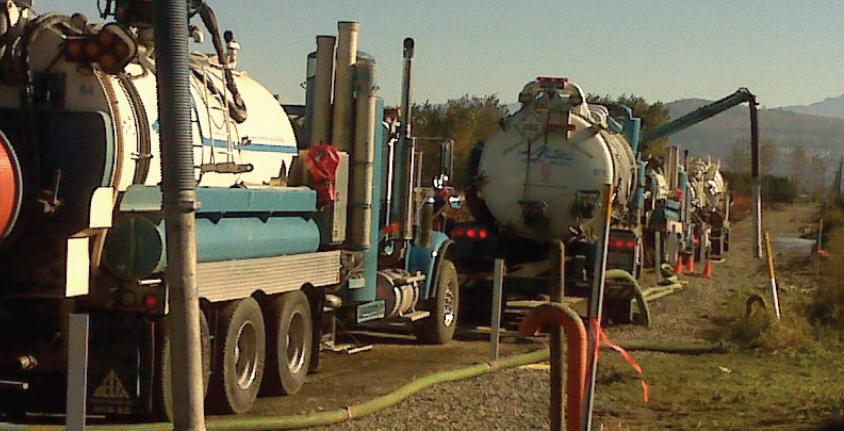 Hydrovac trucks along a roadway