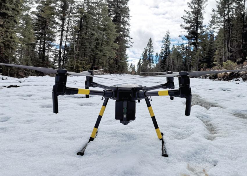 A drone sits on a snow covered ground