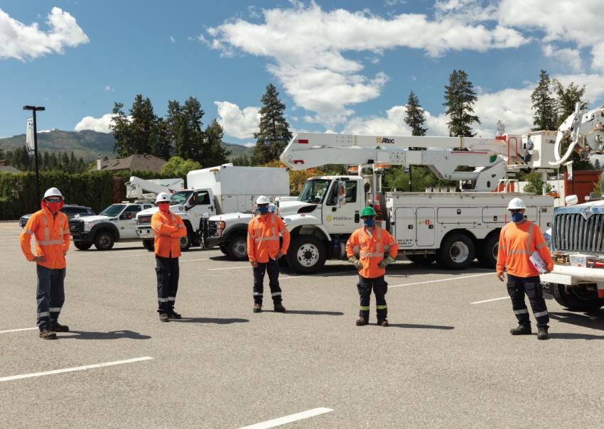 FortisBC workers practicing social distancing while wearing PPE