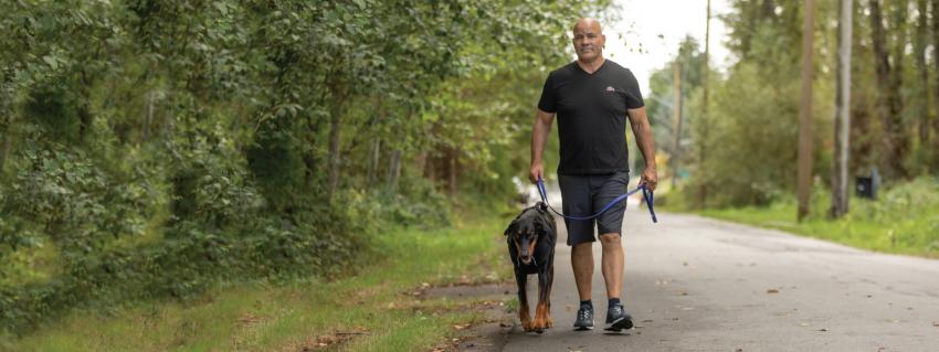 Greg Edgelow walks his dog along the Burnaby multi-use pathway