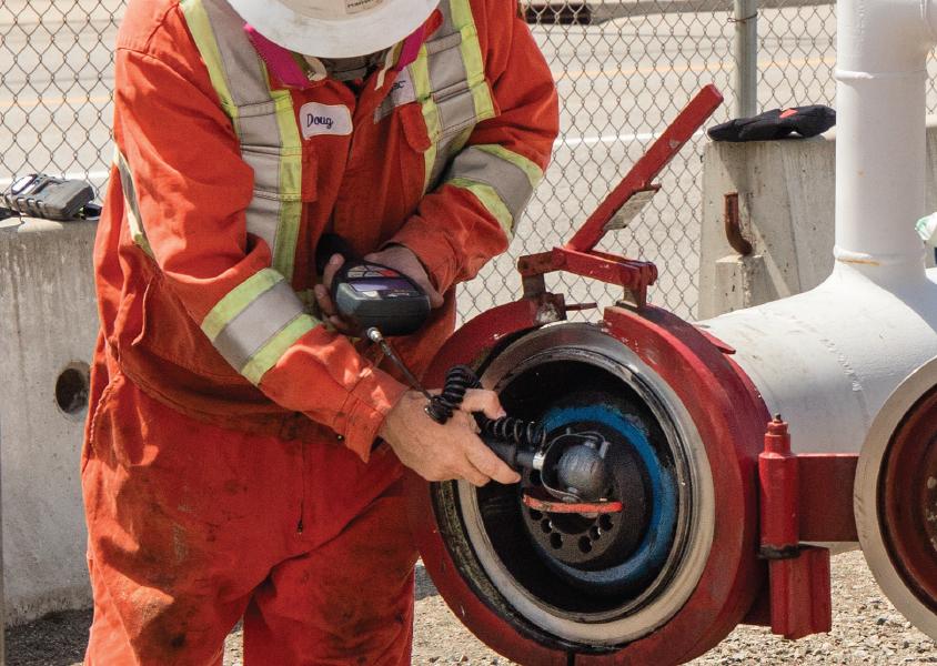 FortisBC employee tests a fitting in a gas line