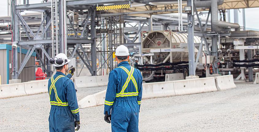 Workers with their backs to the camera at the Tilbury LNG facility