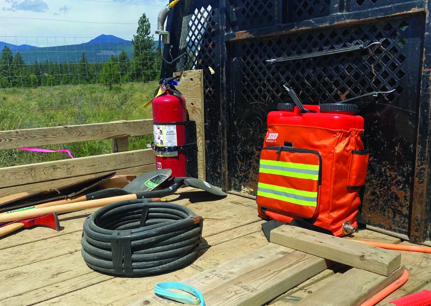 A collection of firefighting tools made accessible to crew members sit in the back of a truck