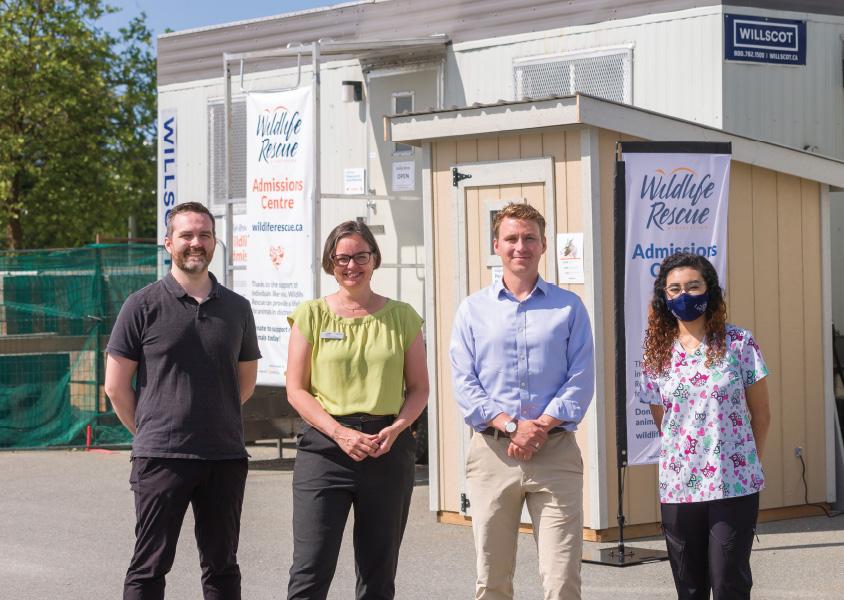four people stand in front of the Wildlife Rescue admissions centre in Burnaby
