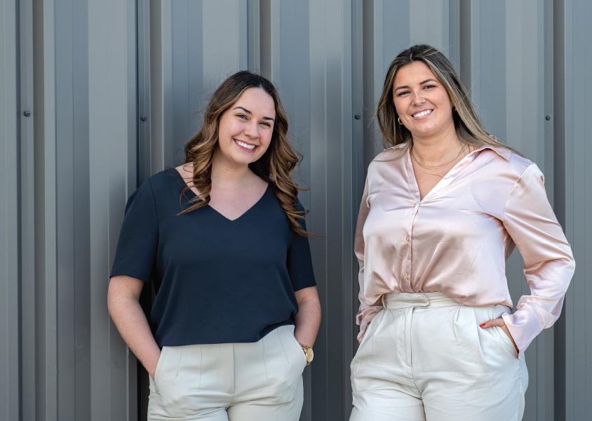 Two FortisBC interns smile at the camera