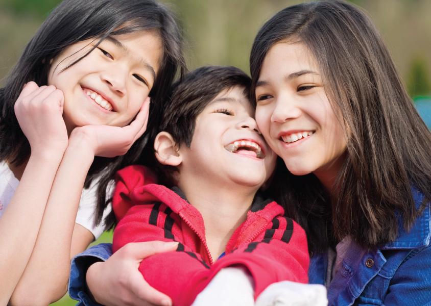 Three smiling siblings