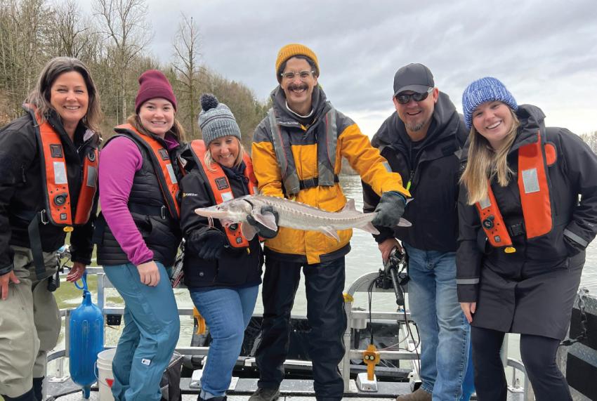 Team holding sturgeon