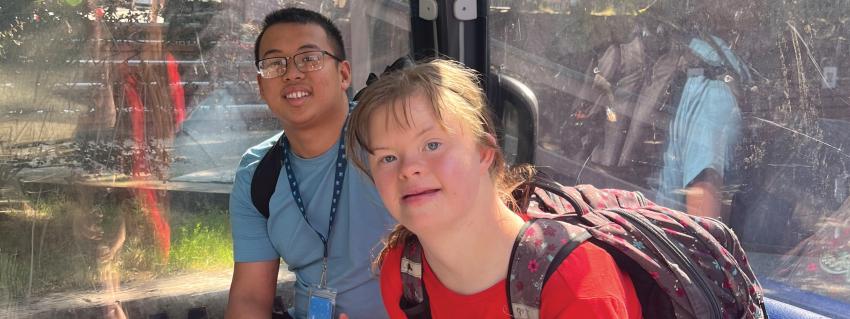 Two people sitting together on public transport