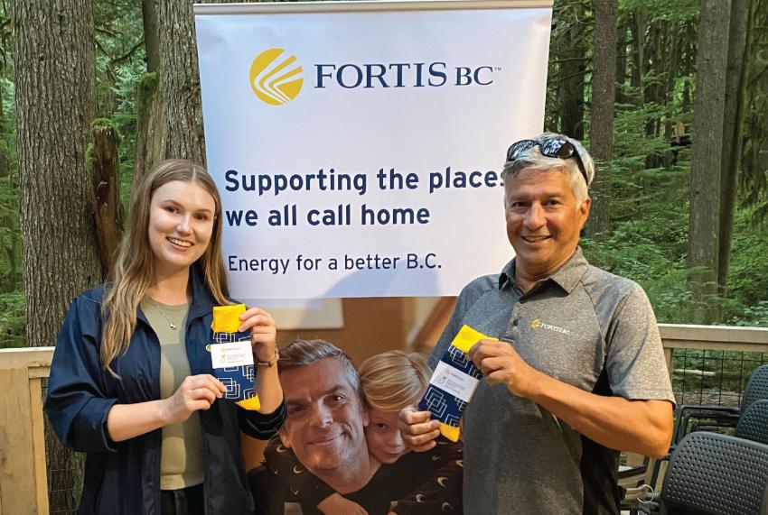 FortisBC’s Cassandra Barrow and Elliot Moses with the popular FortisBC socks.